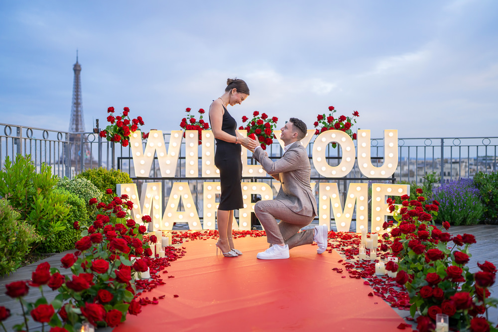 Proposal in Paris with Will you marry me sign and red roses