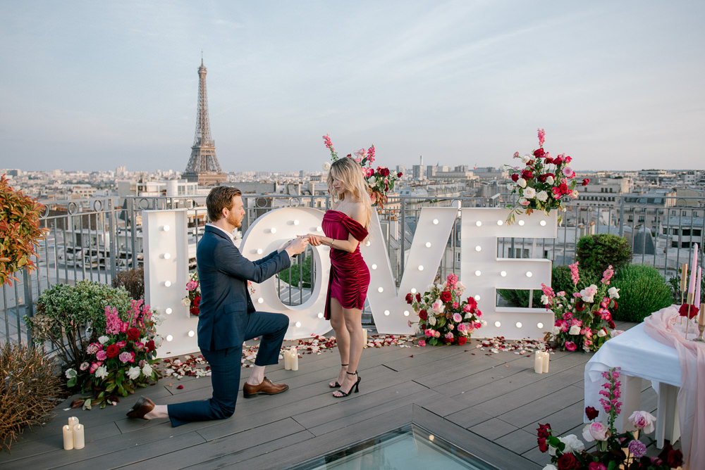 Surprise marriage proposal with LOVE letters on a private rooftop overlooking the Eiffel Tower