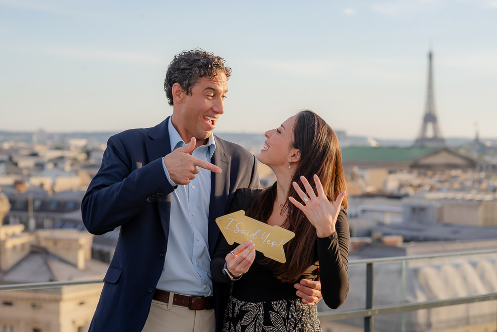 Newly engaged couple holding an 
